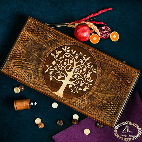 Armenian backgammon set closed with carved pomegranate Tree of Life lid, styled with fresh pomegranates
