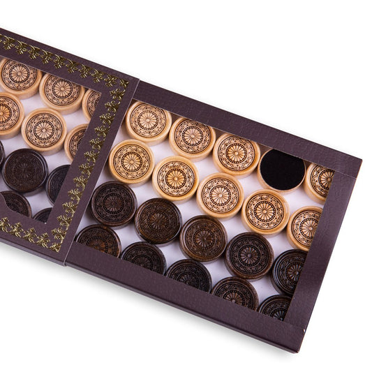 Set of wooden backgammon pieces showing an elegant ornament design.