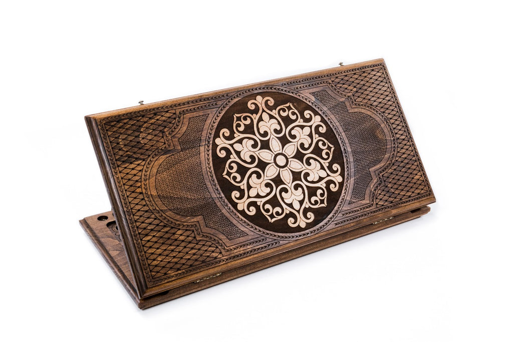 A frontal shot of the closed Ornamental Snowflake backgammon board showing the symmetrical hand-carved relief in solid wood.
