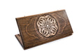 A frontal shot of the closed Ornamental Braid classic backgammon board showing the continuous hand-carved interlaced relief.