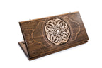 A frontal shot of the closed Ornamental Braid classic backgammon board showing the continuous hand-carved interlaced relief.