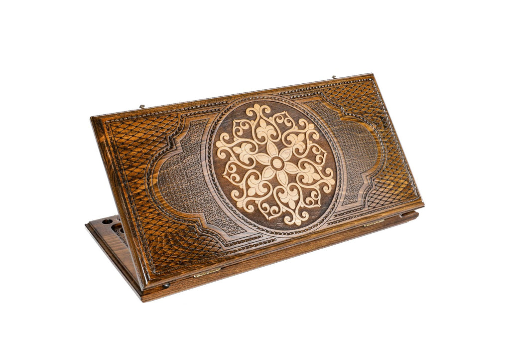A frontal shot of the closed Ornamental Snowflake backgammon board showing the symmetrical hand-carved relief in solid wood.