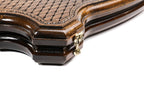 Edge of the closed contour board with the cast-bronze clasp and layered lattice lid