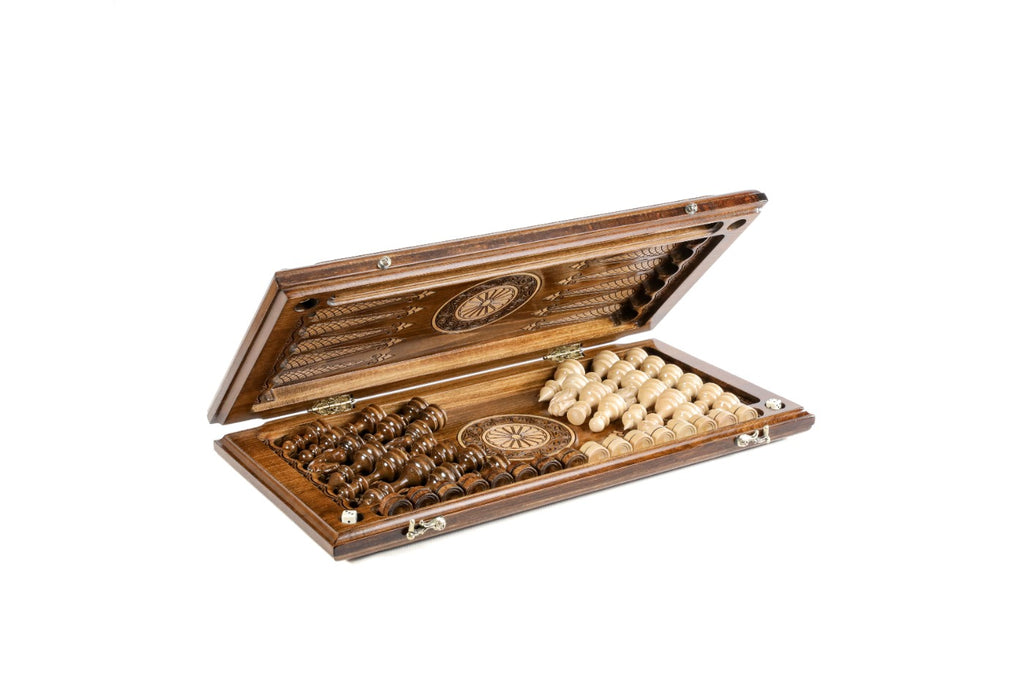 Chess backgammon set half open with the carved pieces stored on the backgammon field
