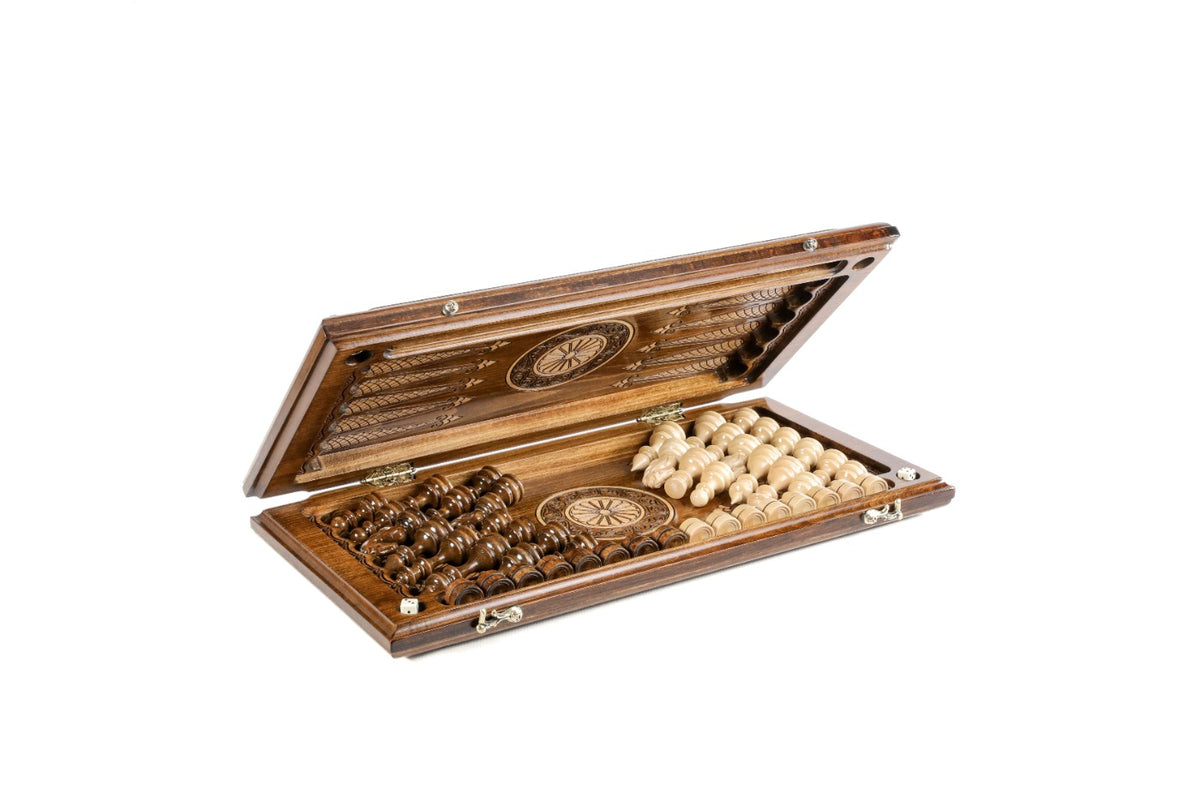 Chess backgammon set half open with the carved pieces stored on the backgammon field