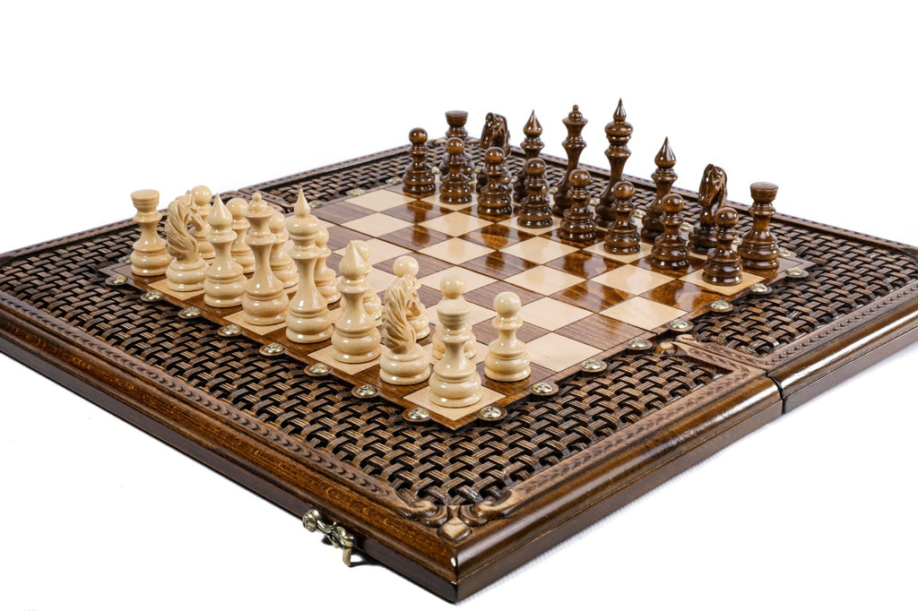 Hand-carved braid ornament border of the wooden chess board with carved pieces, close angle
