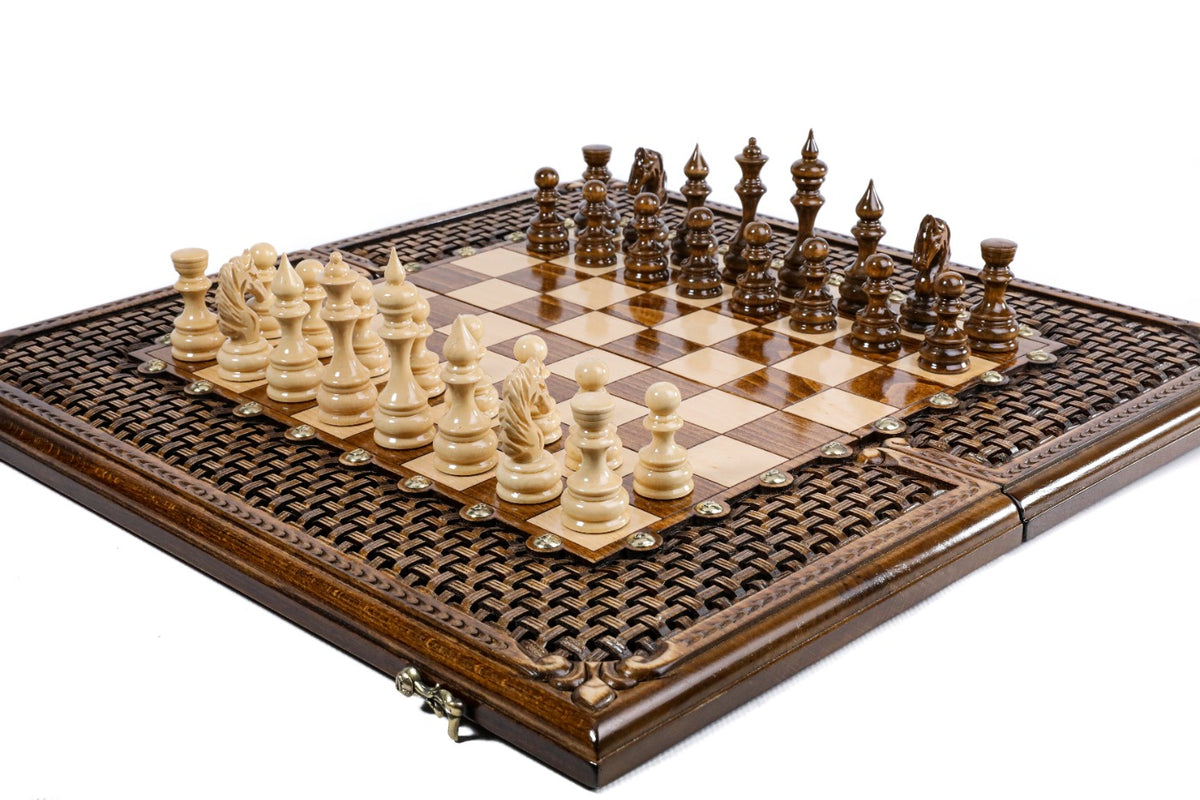 Hand-carved braid ornament border of the wooden chess board with carved pieces, close angle