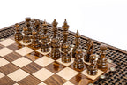 Dark hand-carved chess pieces on the beech and walnut squares beside the braid frame