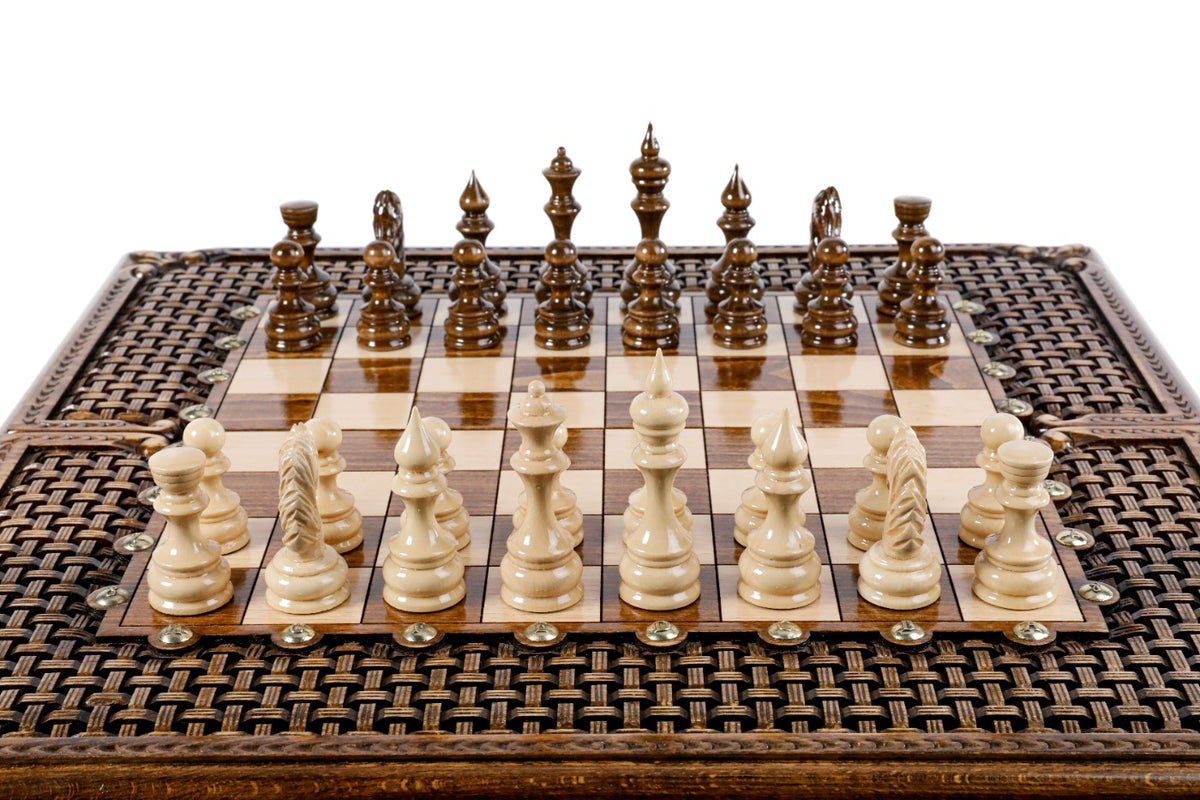 Front view of the luxury chess set with carved braid border and hand-carved pieces in position
