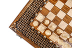 Close view of the woven braid carving and light chess pieces at the board edge
