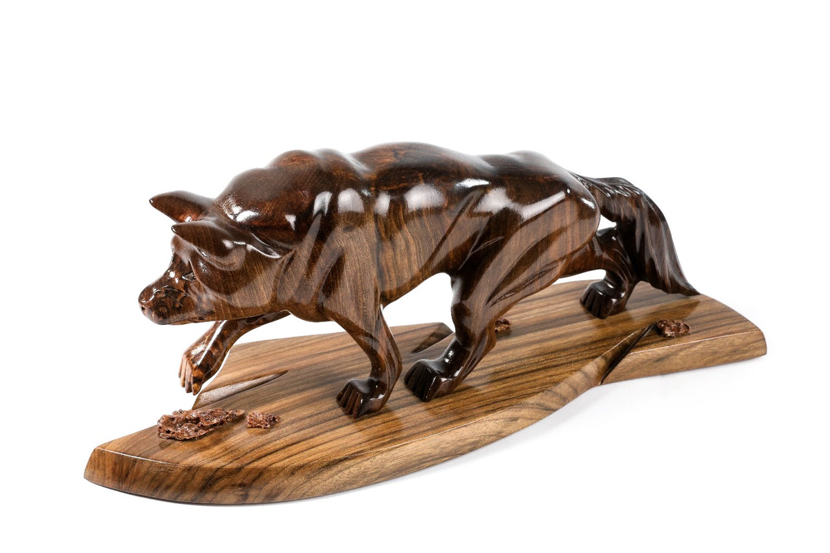 Wolf sculpture in carved walnut wood — side view