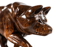 Hand-carved walnut wolf sculpture — profile view
