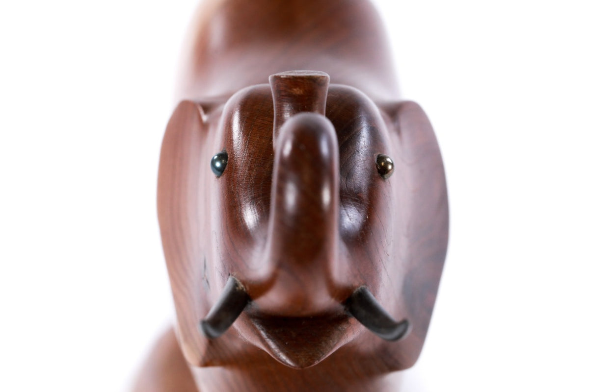Wooden elephant sculpture with metal accents — close-up