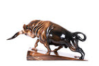 Bull sculpture in carved wood — side view