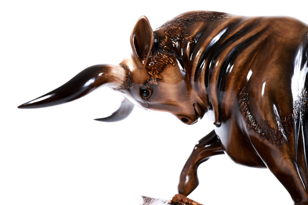 Hand-carved bull sculpture — profile view