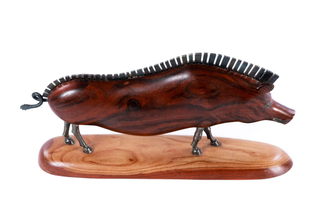 Wooden wild boar sculpture with metal accents — close-up