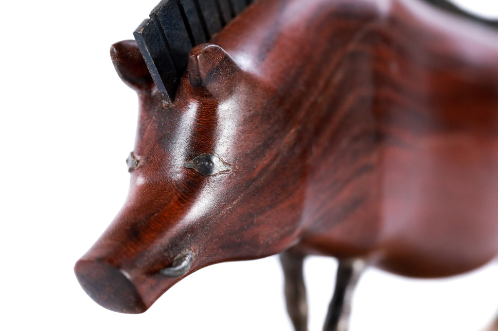 Wild boar sculpture in carved apricot wood — side view