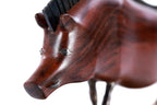 Wild boar sculpture in carved apricot wood — side view