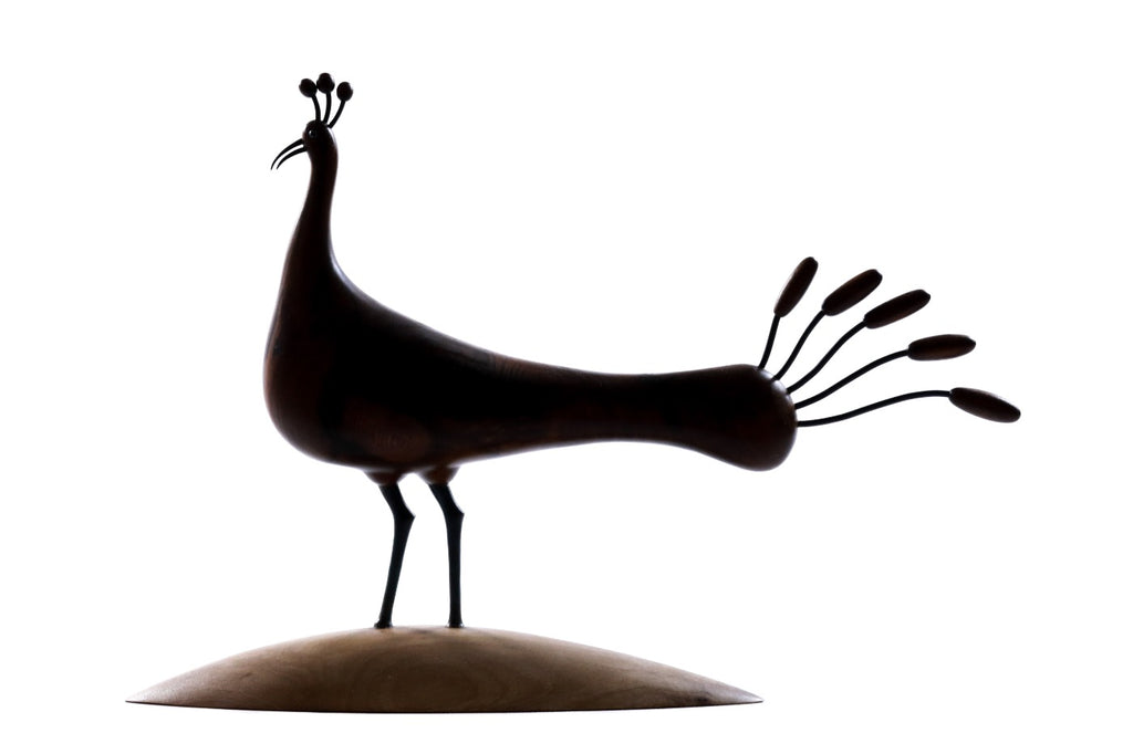 Hand-carved peacock sculpture, reverse side view