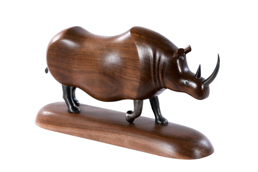 Walnut rhinoceros sculpture hand carved with metal pieces — detail view