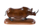 Wooden rhinoceros sculpture with metal accents — close-up