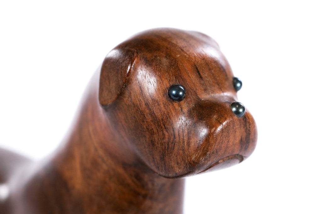 Dog sculpture in carved walnut wood — side view