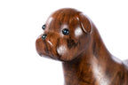 Wooden dog sculpture with metal accents — close-up