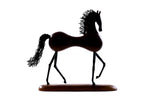 Wooden horse sculpture with metal accents — close-up