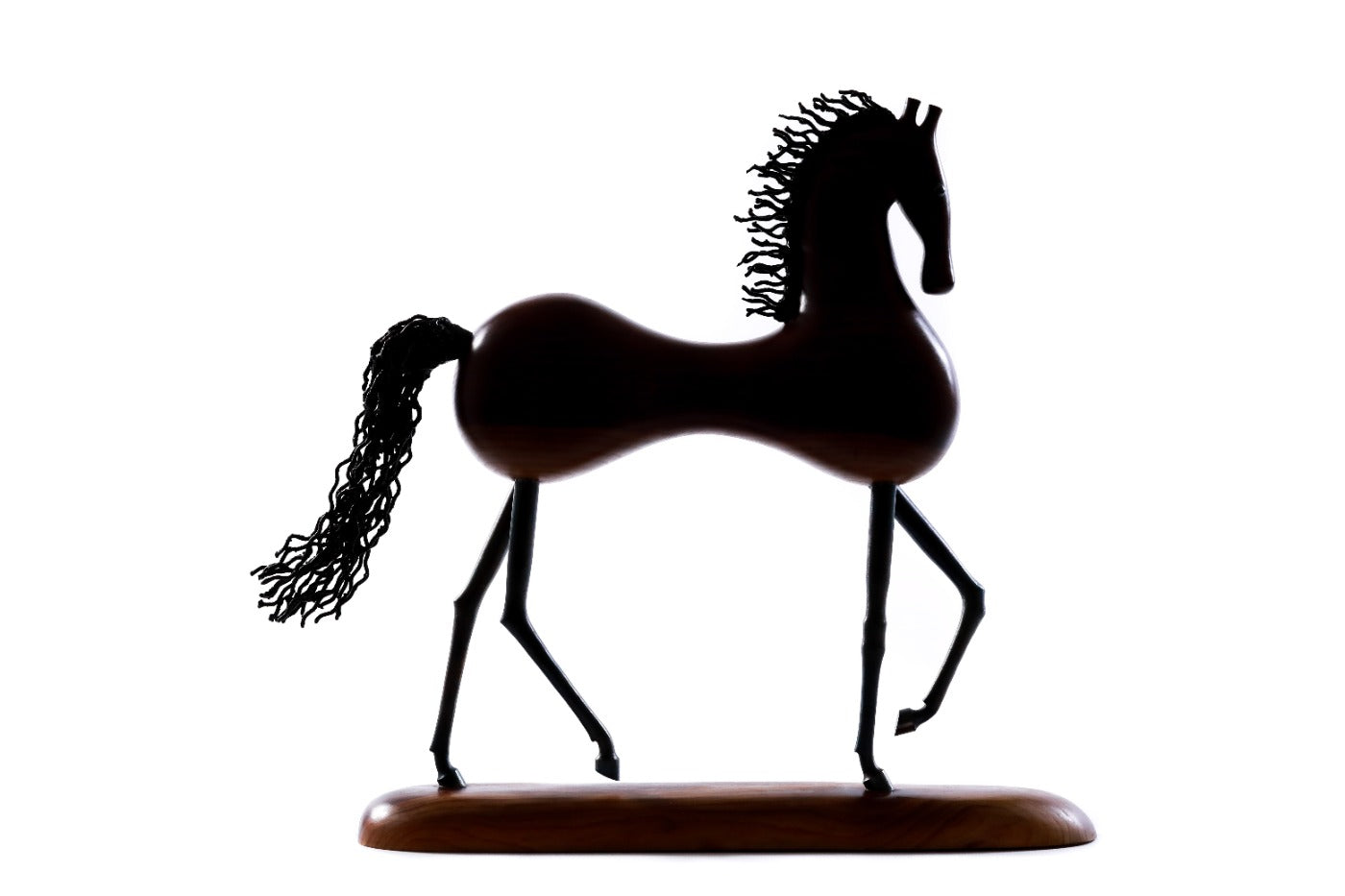 Wooden horse sculpture with metal accents — close-up