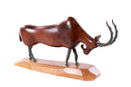 Wooden goat sculpture hand carved with metal pieces — detail view