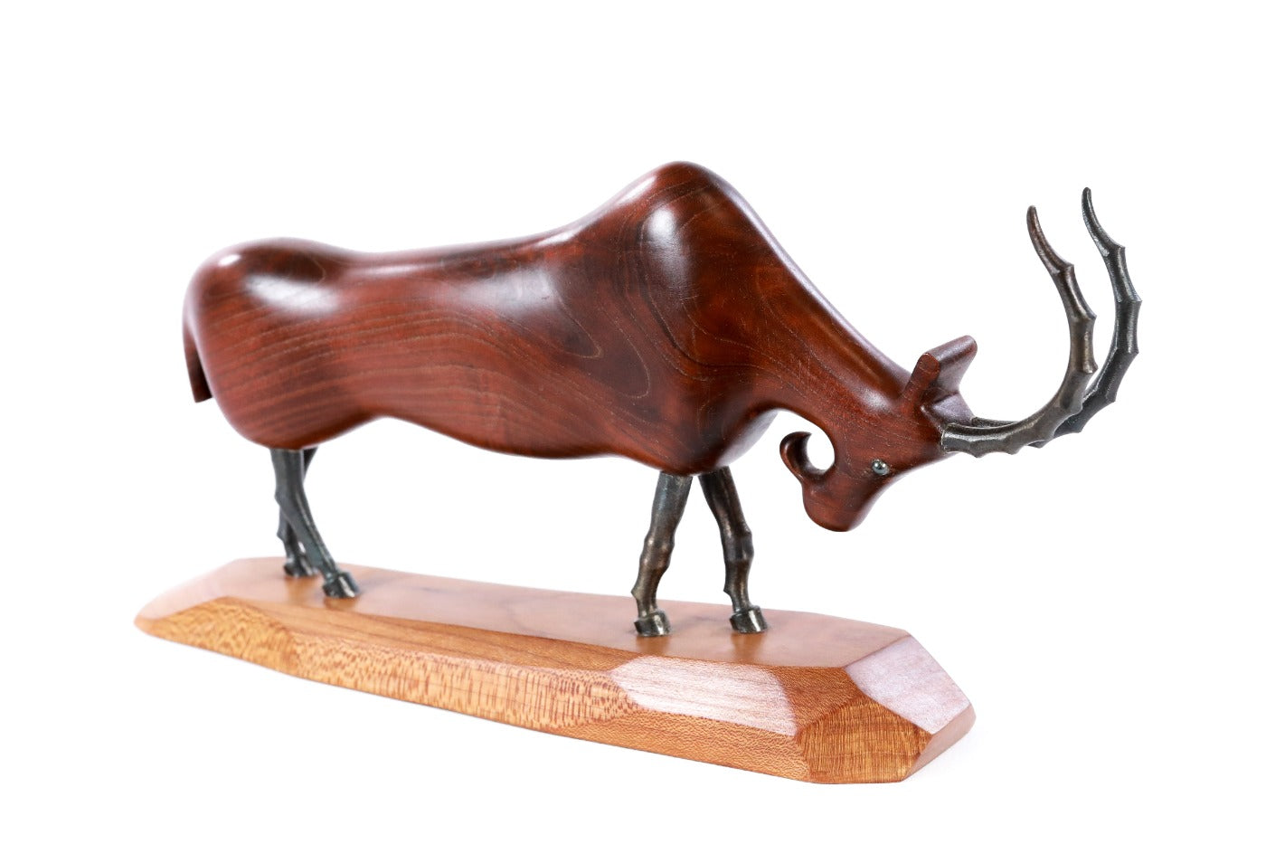 Wooden goat sculpture hand carved with metal pieces — detail view