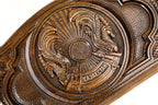 Detail view of the hand-carved Kazakh national emblem on solid wood.