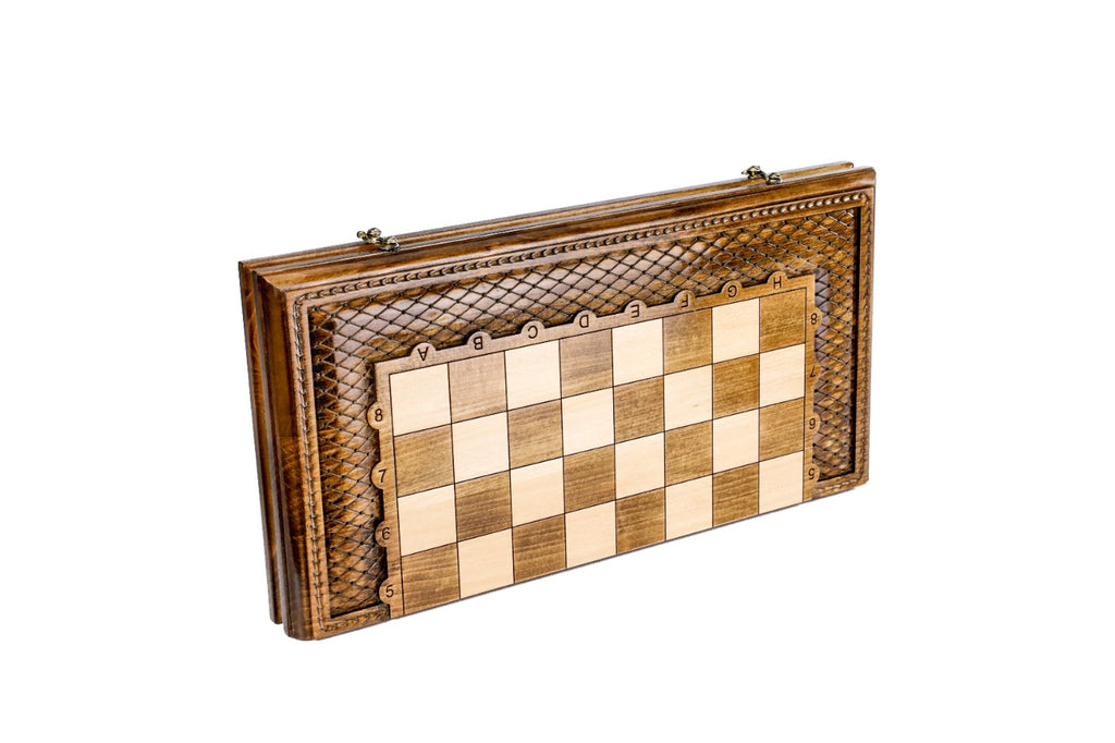 Closed wooden chess and backgammon board with lattice ornament carved around the squares