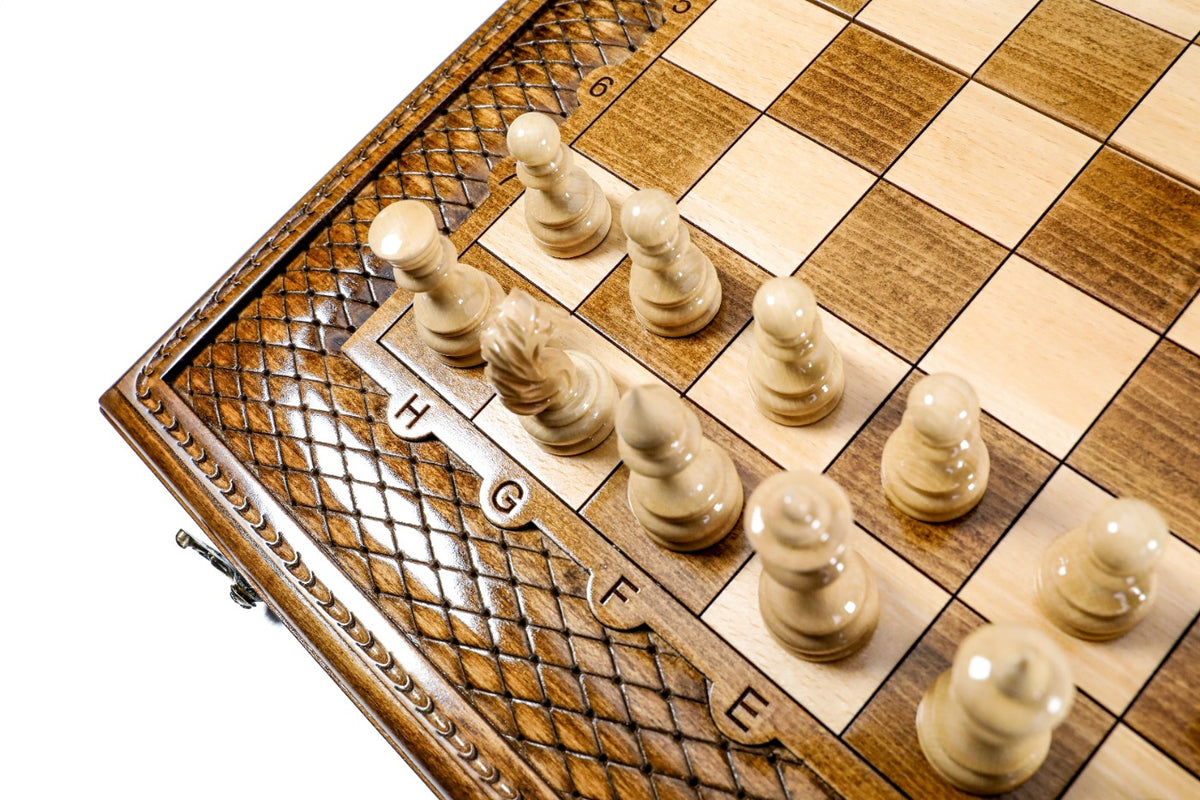Light hand-carved chess pieces on the wooden chess board beside the lattice border