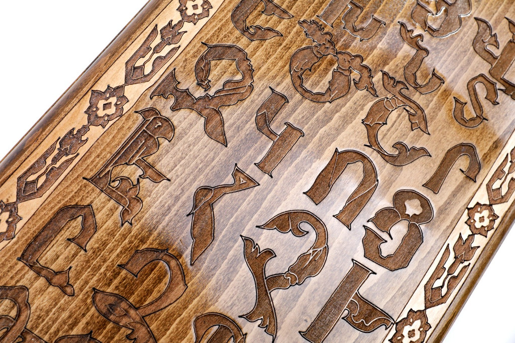 The interior view of the open Hrachya Ohanyan Alphabet set highlighting the smooth wood finish and professional pips.