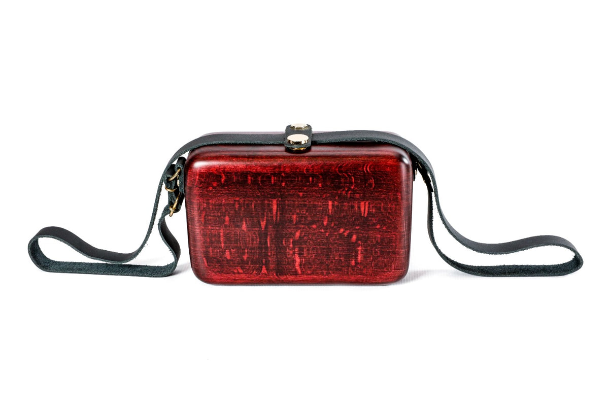 Burgundy wooden bag with leather strap — side view