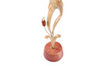 Wooden sculpture of a pregnant woman — close-up