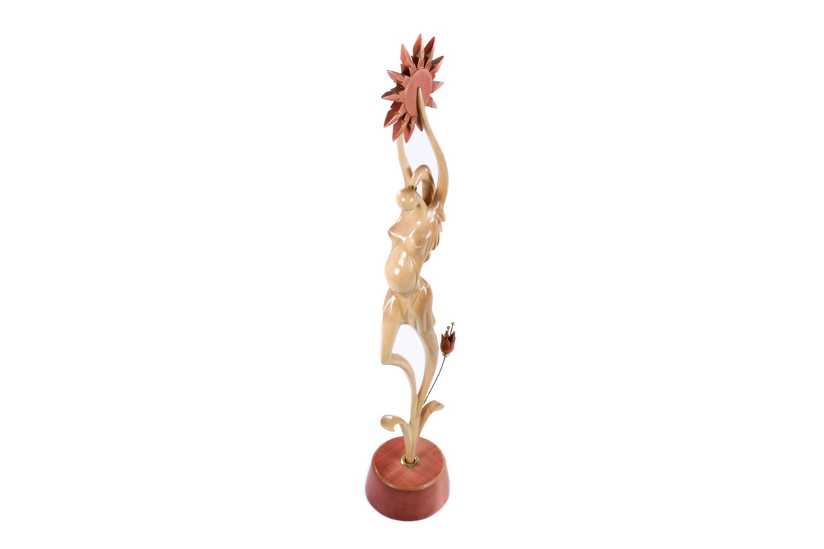 Hand-carved pregnant woman sculpture — profile view