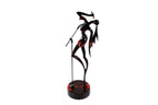 Hand-carved singer figure sculpture — back view