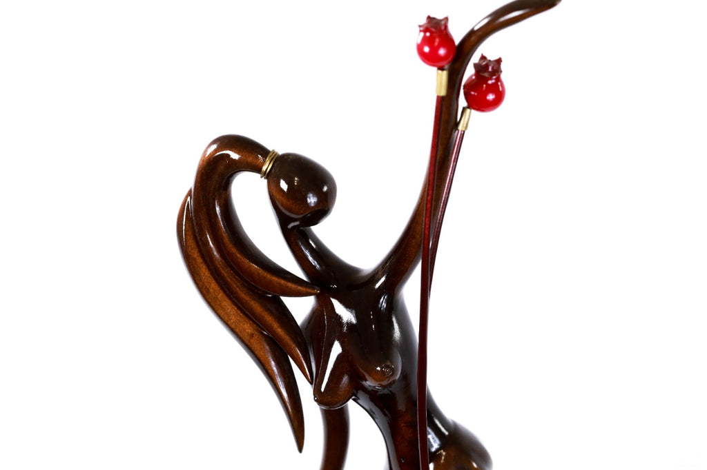 Hand-carved Armenian figure sculpture with pomegranates — back view