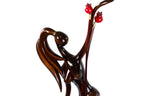 Hand-carved Armenian figure sculpture with pomegranates — back view