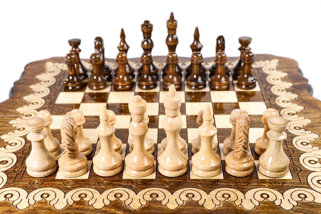 Small handcrafted chess set with elegant pattern design and backgammon board 