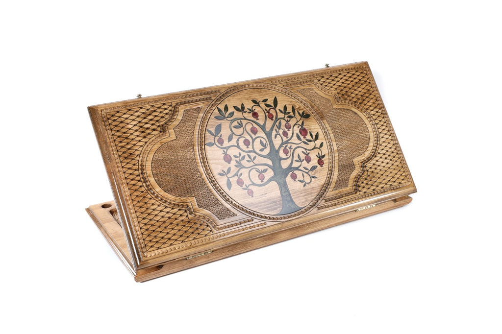 A frontal shot of the closed Pomegranate Tree backgammon board featuring vibrant green epoxy resin and high-relief wood carving.