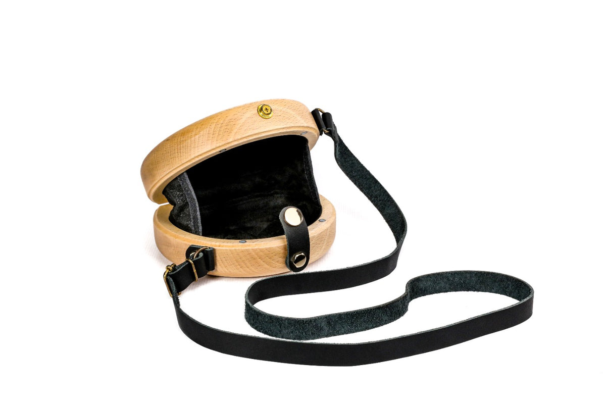 Natural wooden bag with black leather strap — side view