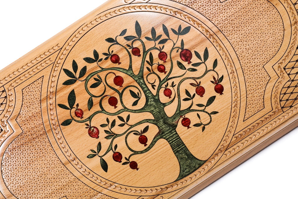 An angled view of the Hrachya Ohanyan board showing the glossy ruby resin against the natural solid wood grain.