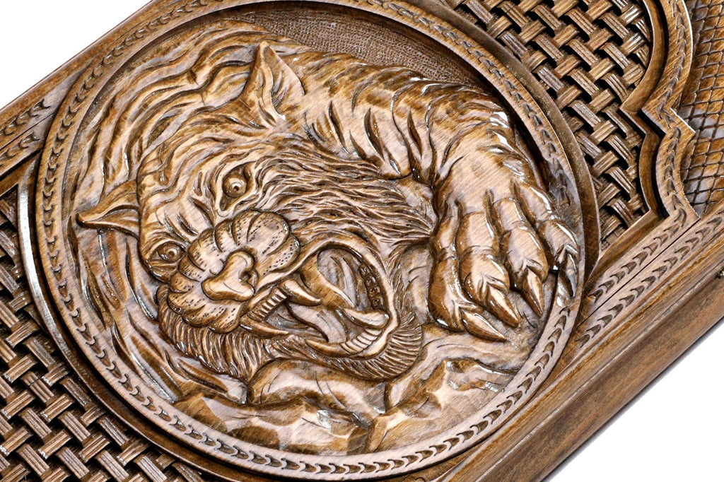 An angled close-up of the tiger's face and whiskers, highlighting the intricate detail and depth of the solid wood.