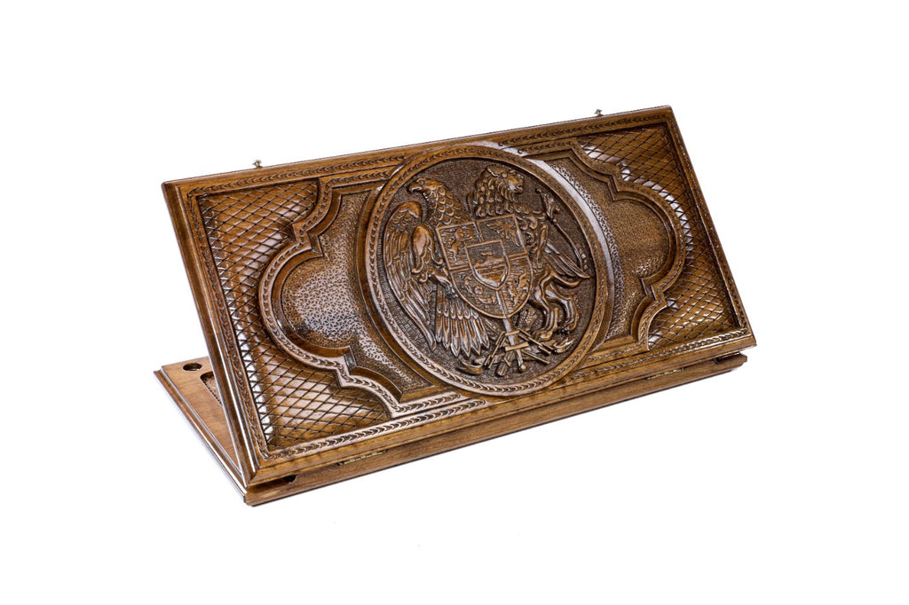 A frontal shot of the closed Coat of Arms classic backgammon board showing the detailed heraldic carving in solid wood.