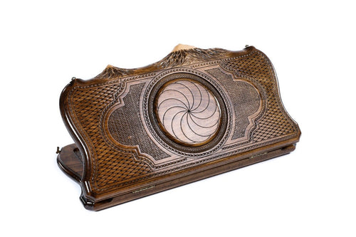A frontal shot of the closed Eternity backgammon board featuring the high-relief Sun Cross within the copyrighted Mount Ararat outline.