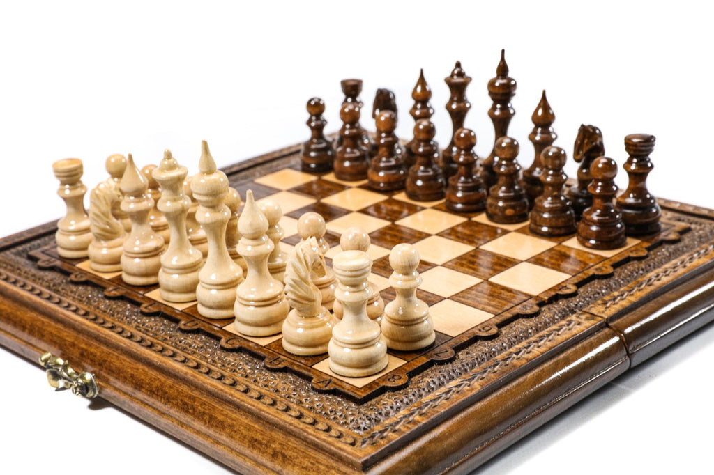 wooden chess board with detailed carved pieces