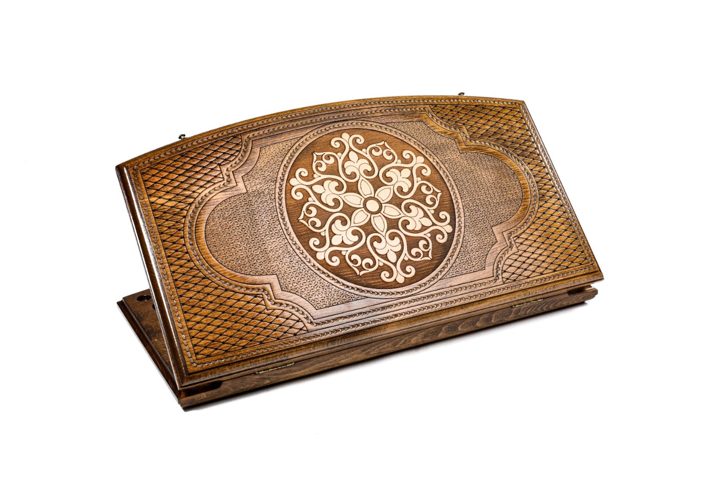 Closed backgammon board showing the ornamental snowflake motif framed by a hand-carved arch outline.